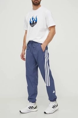 Zdjęcie produktu adidas spodnie dresowe kolor niebieski z nadrukiem IR9239