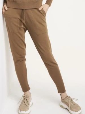 Zdjęcie produktu Beżowe spodnie dresowe damskie OCHNIK