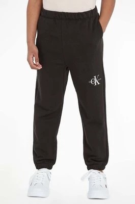 Zdjęcie produktu Calvin Klein Jeans spodnie dresowe dziecięce kolor czarny gładkie