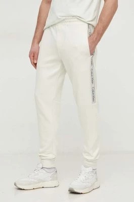 Zdjęcie produktu Calvin Klein spodnie dresowe kolor beżowy z aplikacją