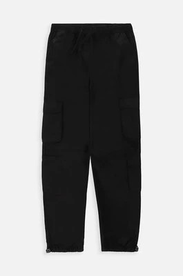 Zdjęcie produktu Coccodrillo spodnie bawełniane dziecięce kolor czarny gładkie