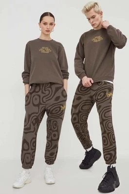 Zdjęcie produktu Converse spodnie dresowe bawełniane Converse x Wonka kolor brązowy wzorzyste