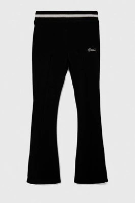 Zdjęcie produktu Guess spodnie dresowe dziecięce kolor czarny gładkie