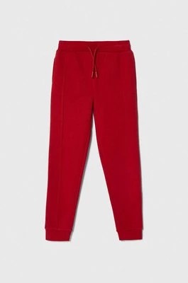 Zdjęcie produktu Guess spodnie dresowe dziecięce kolor czerwony gładkie