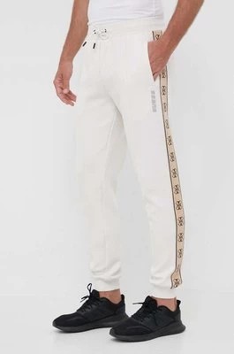 Zdjęcie produktu Guess spodnie dresowe MICKEY męskie kolor beżowy z nadrukiem Z2YB09 KB3P2