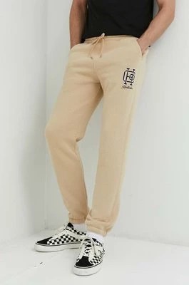 Zdjęcie produktu Hollister Co. spodnie dresowe męskie kolor beżowy z nadrukiem