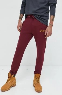 Zdjęcie produktu Hollister Co. spodnie dresowe męskie kolor bordowy z aplikacją