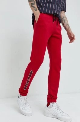 Zdjęcie produktu Hollister Co. spodnie dresowe męskie kolor czerwony z nadrukiem