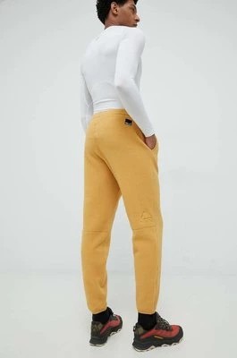 Zdjęcie produktu Jack Wolfskin spodnie dresowe męskie kolor żółty