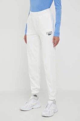 Zdjęcie produktu Lacoste spodnie dresowe kolor beżowy z nadrukiem