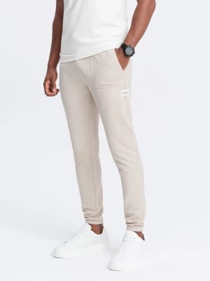 Zdjęcie produktu Męskie spodnie dresowe ze strukturalnej dzianiny - jasnobeżowe V1 OM-PASK-0211
 -                                    XL