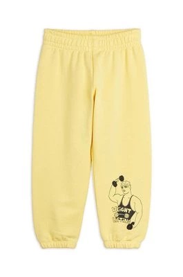 Zdjęcie produktu Mini Rodini spodnie dresowe bawełniane dziecięce Weight lifting kolor żółty gładkie