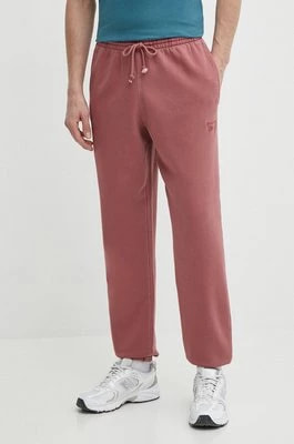 Zdjęcie produktu Reebok spodnie dresowe kolor bordowy gładkie 100076352