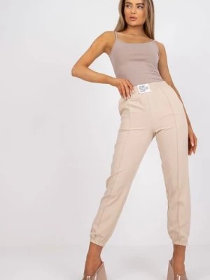 Zdjęcie produktu Spodnie damskie ze ściągaczami beżowe Italy Moda