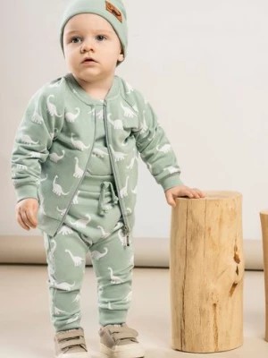 Zdjęcie produktu Spodnie dresowe baggy niemowlęce oliwkowe- białe dinozaury Nicol