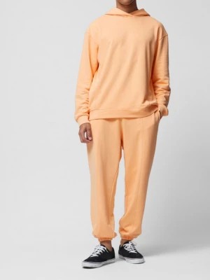 Zdjęcie produktu Spodnie dresowe joggery męskie - pomarańczowe OUTHORN