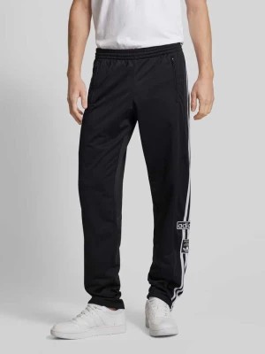 Zdjęcie produktu Spodnie dresowe o kroju regular fit z naszywkami z logo model ‘ADIBREAK’ adidas Originals