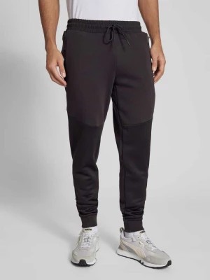Zdjęcie produktu Spodnie dresowe o kroju slim fit z kieszeniami zapinanymi na zamek błyskawiczny model ‘PUMATECH’ PUMA PERFORMANCE