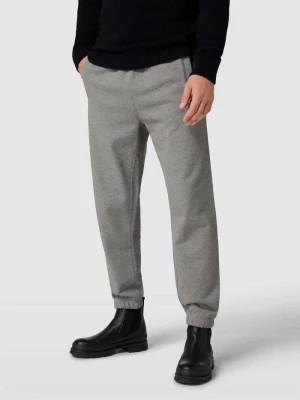 Zdjęcie produktu Spodnie dresowe z nadrukiem z napisem Lacoste