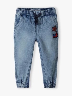 Zdjęcie produktu Spodnie jeansowe dziewczęce typu jogger z gwiazdką Minoti