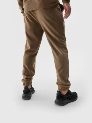 Zdjęcie produktu Spodnie polarowe joggery męskie - brązowe 4F