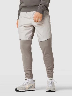 Zdjęcie produktu Spodnie typu track pants w dwóch kolorach Under Armour