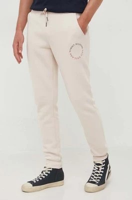 Zdjęcie produktu Tommy Hilfiger spodnie dresowe kolor beżowy z nadrukiem