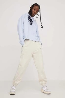 Zdjęcie produktu Tommy Jeans spodnie dresowe bawełniane kolor beżowy z aplikacją DW0DW17309