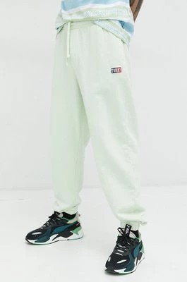 Zdjęcie produktu Tommy Jeans spodnie dresowe bawełniane kolor zielony z aplikacją