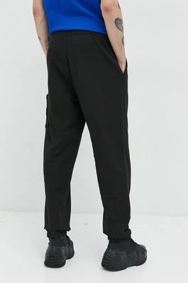 Zdjęcie produktu Tommy Jeans spodnie dresowe bawełniane męskie kolor czarny gładkie