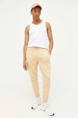 Zdjęcie produktu Tommy Jeans spodnie dresowe kolor beżowy z aplikacją