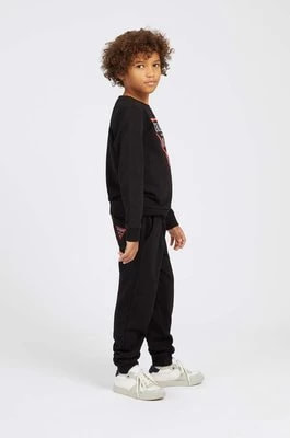 Zdjęcie produktu Guess Spodnie dziecięce kolor czarny gładkie