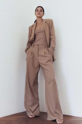 Zdjęcie produktu MUUV. spodnie damskie kolor beżowy szerokie high waist