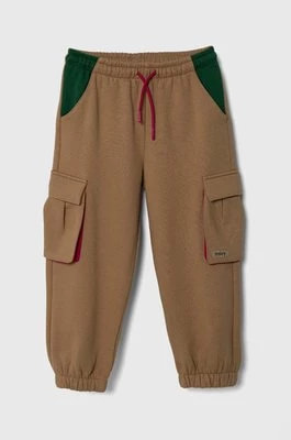 Zdjęcie produktu Sisley spodnie dresowe dziecięce kolor beżowy gładkie